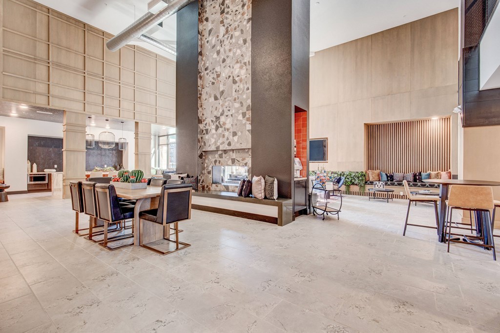 Great room with two-story fireplace, seating and coffee machine