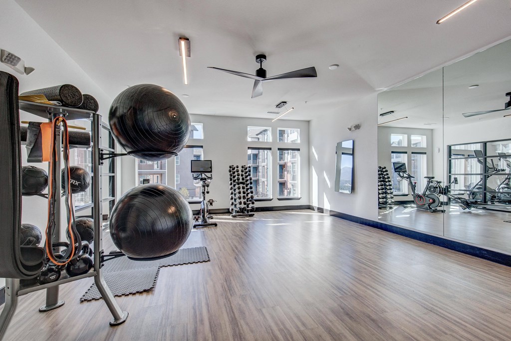Yoga studio with medicine balls, stationary bike and free weights