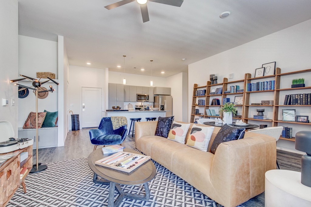 Unit 136 model living room with view to kitchen