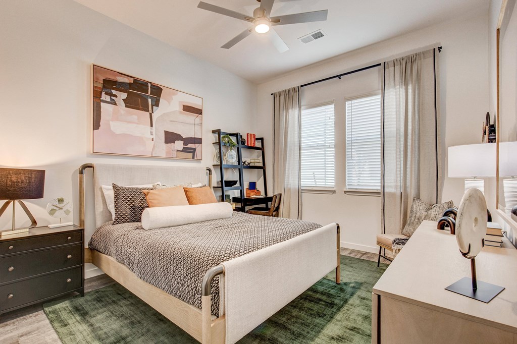 Model bedroom with ceiling fan and window