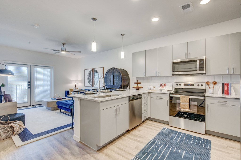 Kitchen  with dishwasher and wood style flooring and gray cabinets