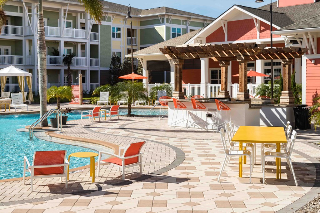 A poolside area with a table and chairs.
