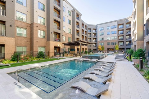 pool with lounge chairs, covered grilling and game area