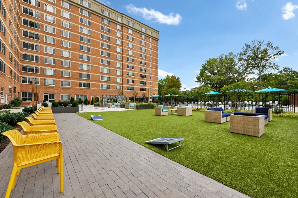 a park with benches and grass in front of a building