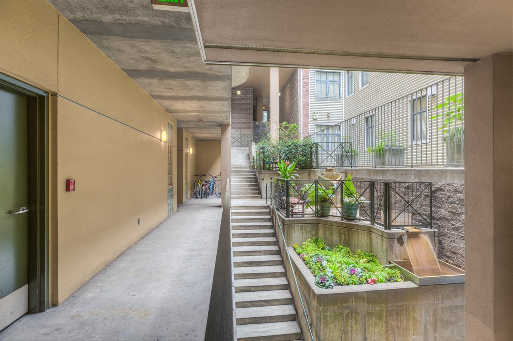 a courtyard with stairs and a water feature in the middle of a building