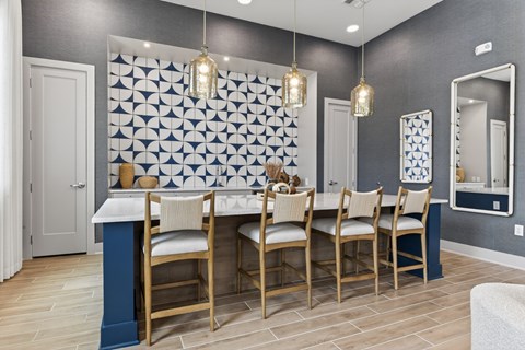 A dining room with a table and chairs.