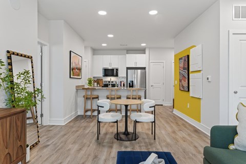 A modern kitchen with a dining table and chairs.