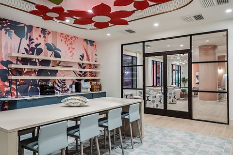 a dining room with a long table and chairs