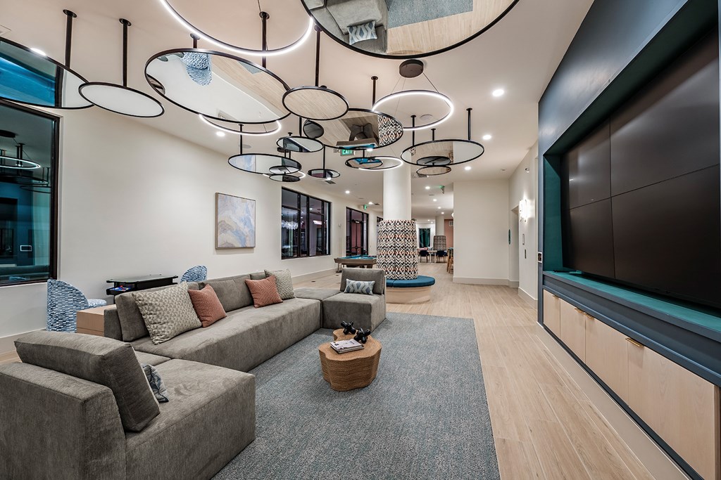 a large living room with couches and a large tv