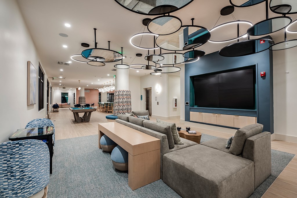 a large living room with couches and a television