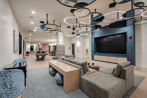 a large living room with couches and a television