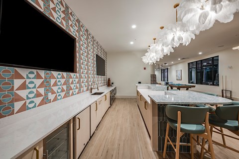 a kitchen with marble counter tops and a table with chairs