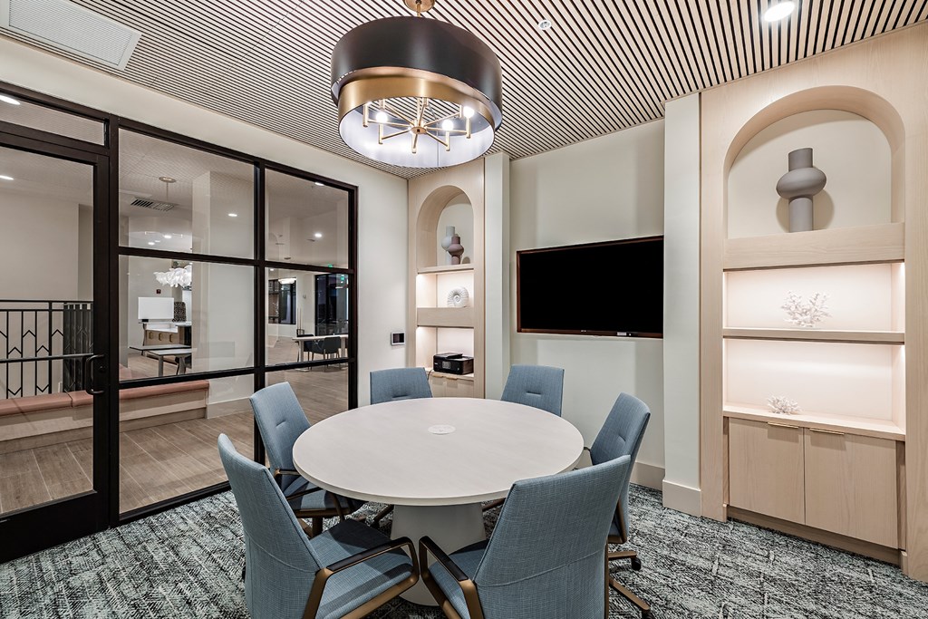 a conference room with a round table and chairs