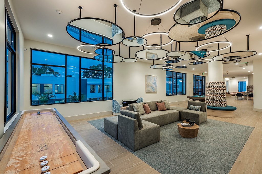 a living room with a couch and a chandelier