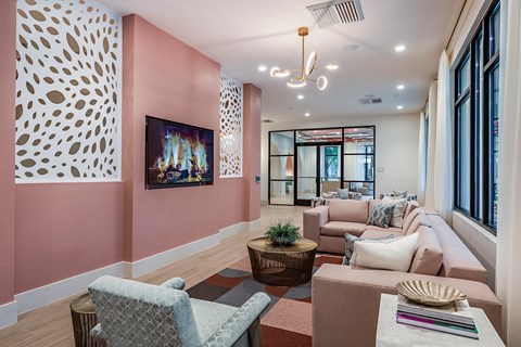 a living room with pink walls and a fireplace