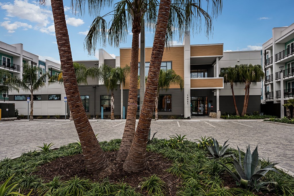 a building with palm trees in front of it