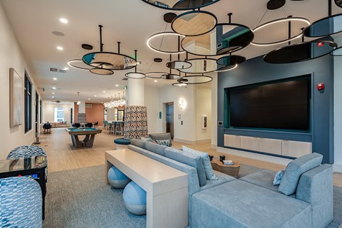 a large living room with a large tv and couches