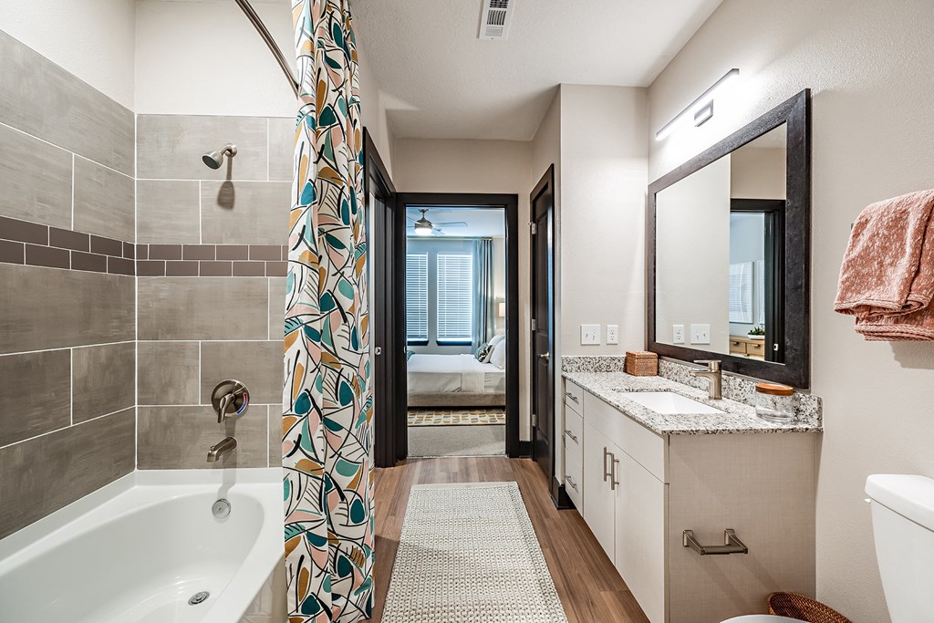 a bathroom with a tub and a sink and a shower