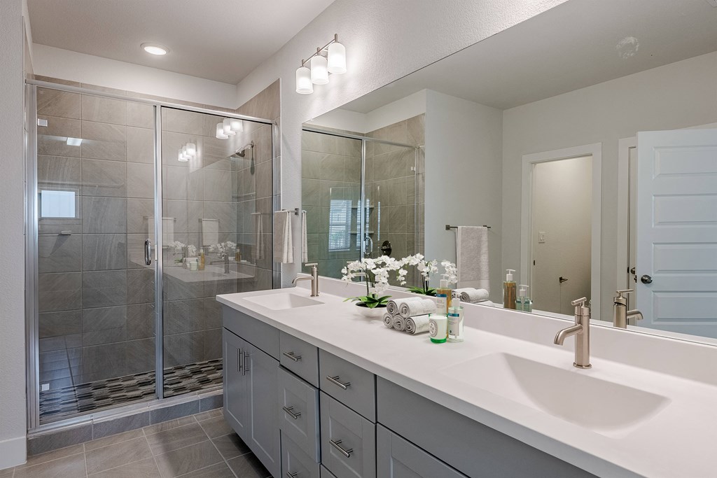 the preserve at ballantyne commons community bathroom with two sinks and a shower