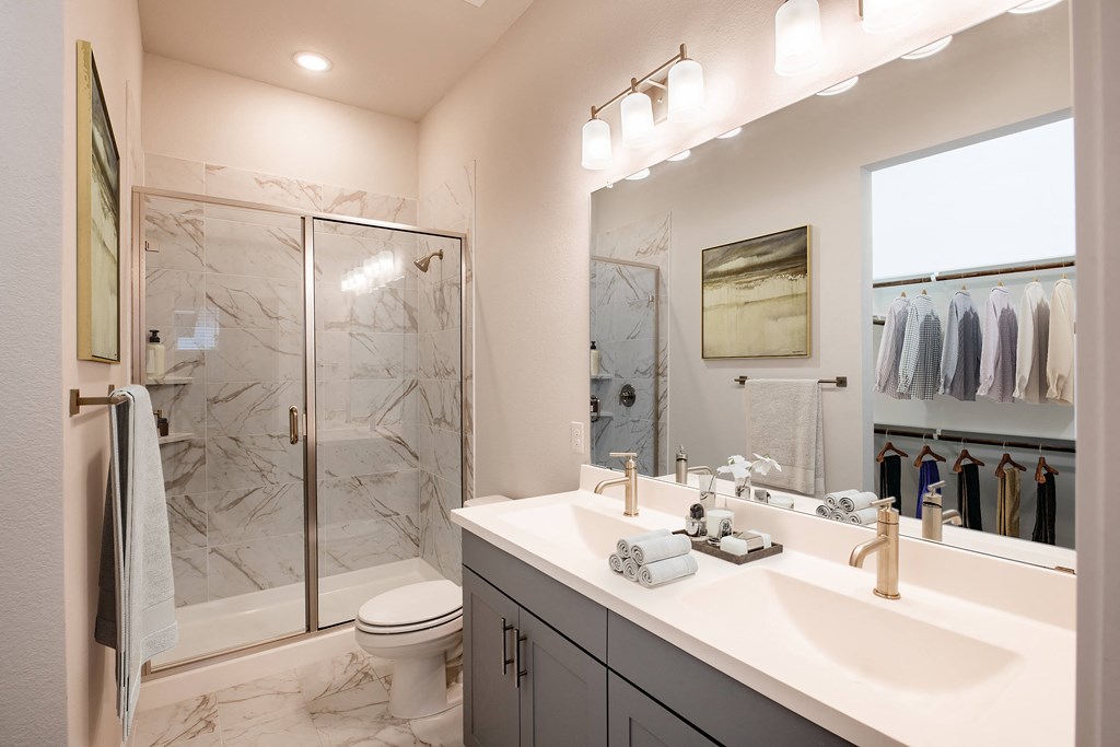a bathroom with a sink and a shower and a toilet