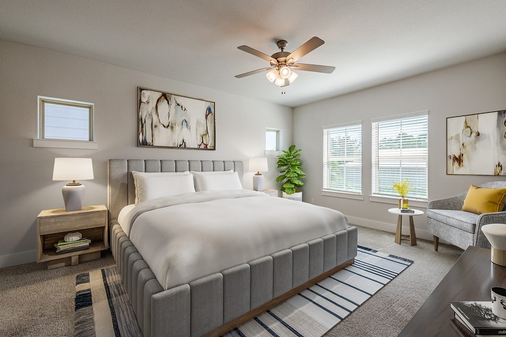 a bedroom with a large bed and a ceiling fan