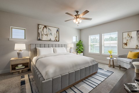 a bedroom with a large bed and a ceiling fan