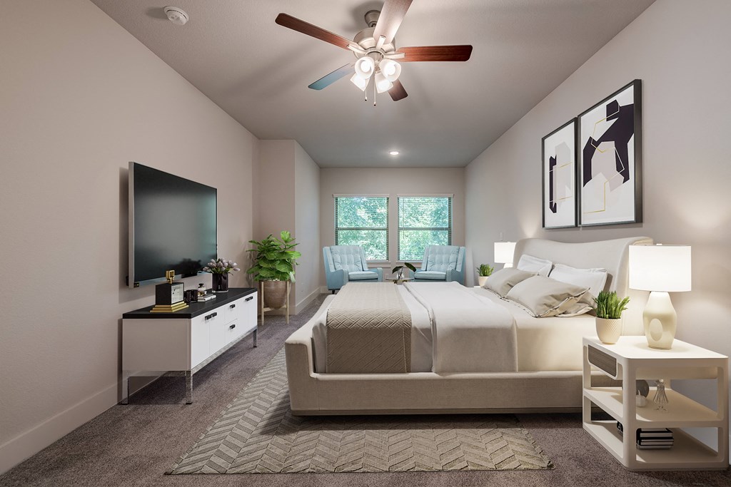 a bedroom with a large bed and a ceiling fan