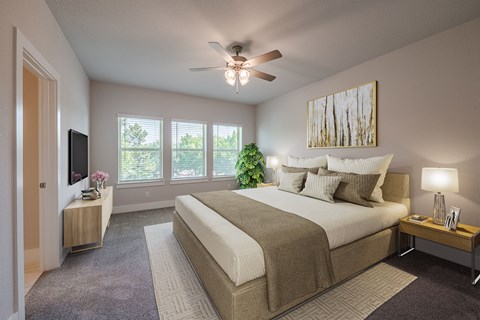 a bedroom with a large bed and a ceiling fan