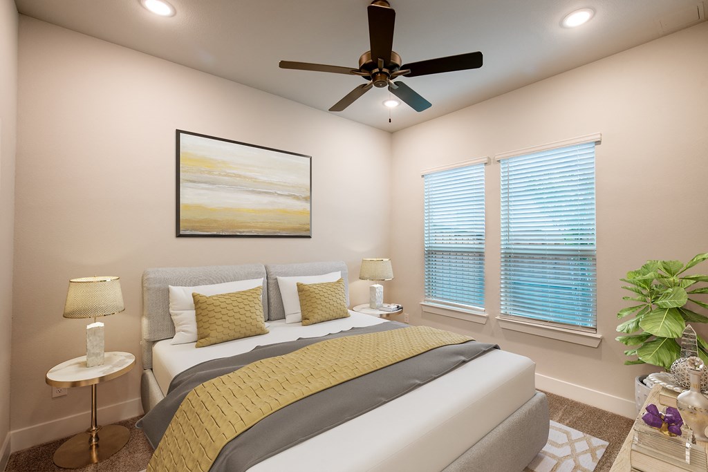 a bedroom with a bed and a ceiling fan