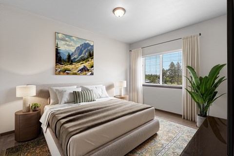A bedroom with a large bed and a painting on the wall.