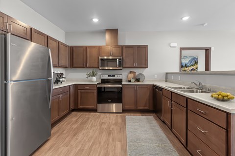 A modern kitchen with wooden cabinets and stainless steel appliances.