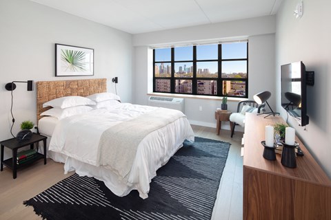 Revetment House Bedroom with Large grid style industrial window and well natural lighting.