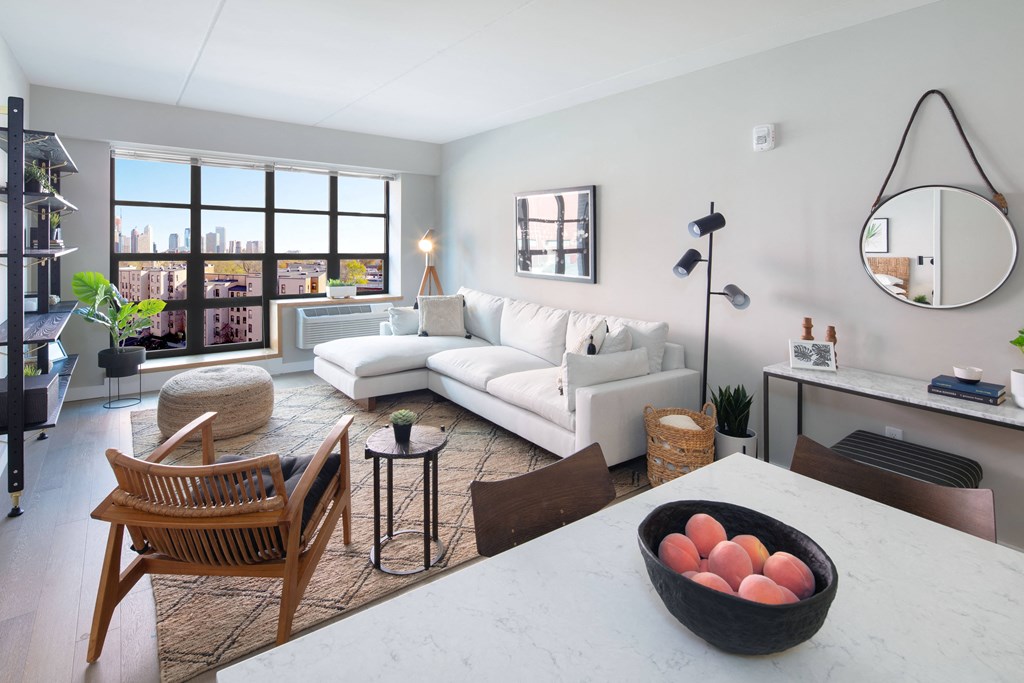 Large open floor concept living room and kitchen with modern finished and large natural lighting window.