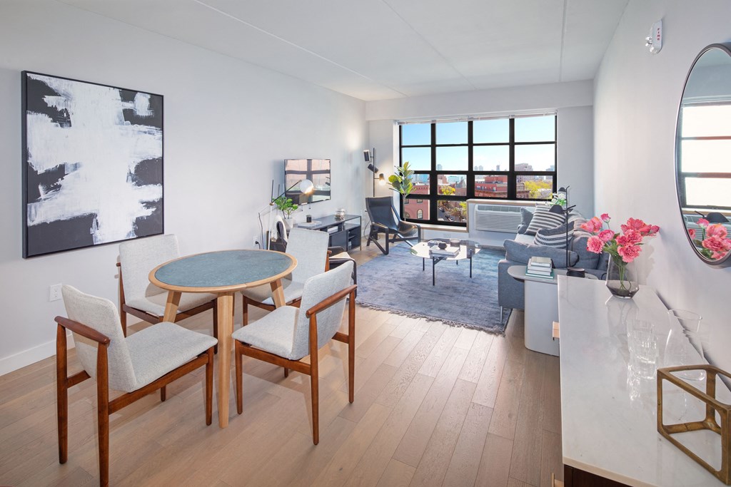 revetment house open space modern one bedroom with lots of natural lighting and a large living room grid style window.