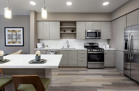 A modern kitchen with a dining table and chairs.