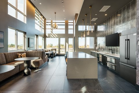 a lobby with couches and a kitchen with a large window