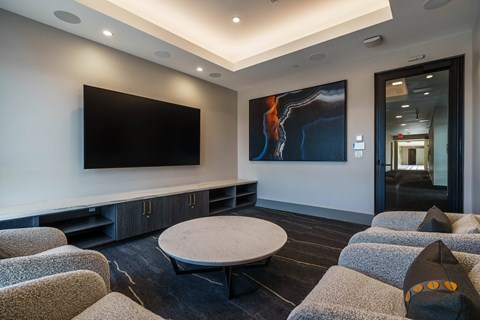 a living room with couches and a table and a television