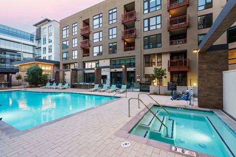 a swimming pool with a building in the background