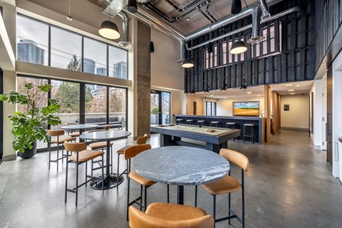 A modern dining area with a large table and chairs.