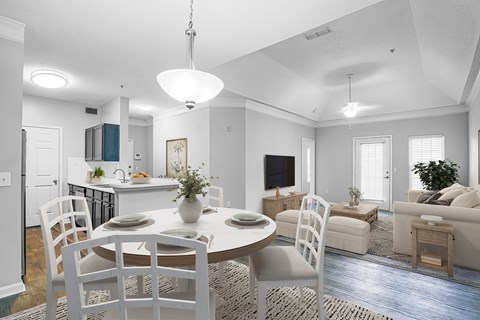 A dining room with a table set for four.