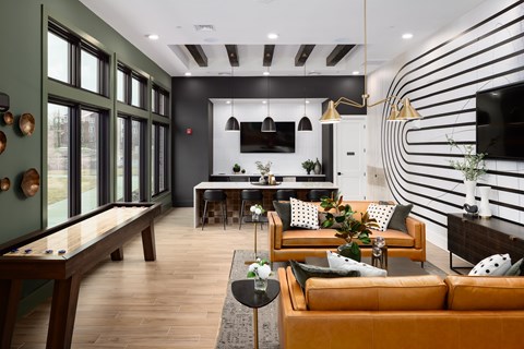 A modern living room with a pool table and a striped wall.