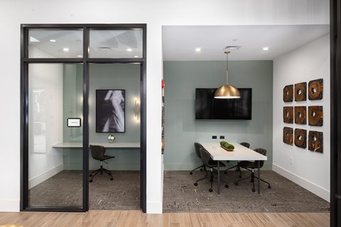 A conference room with a table and chairs.