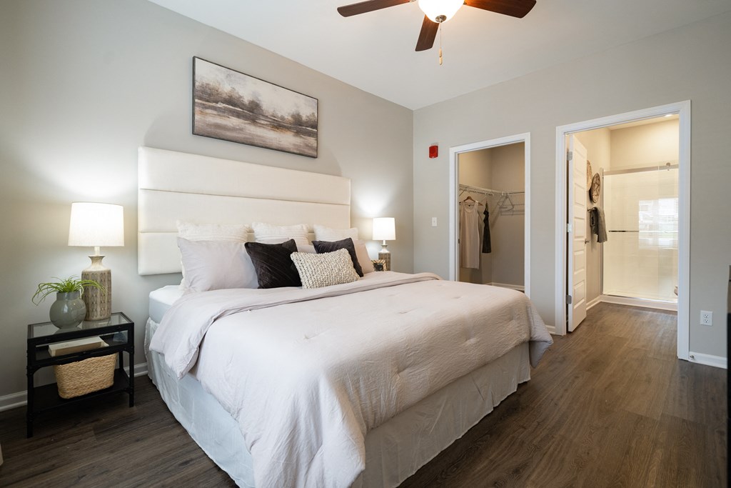 a bedroom with a large bed and a ceiling fan