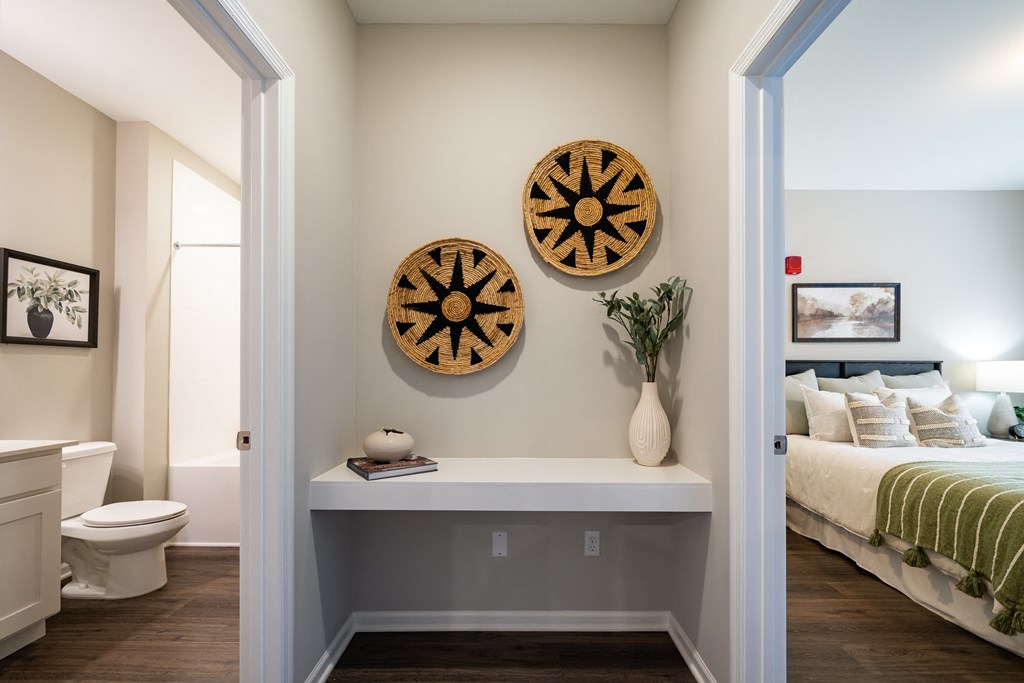 a bedroom with a bed and two clocks on the wall