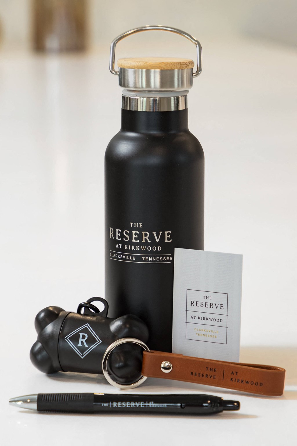 a bottle of the reserve water bottle with a pen and aqualung next to it