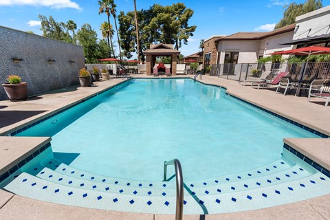 A swimming pool with a metal ladder in the middle.