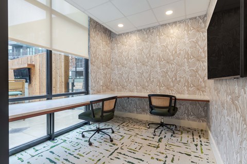 A conference room with a long table and two chairs.