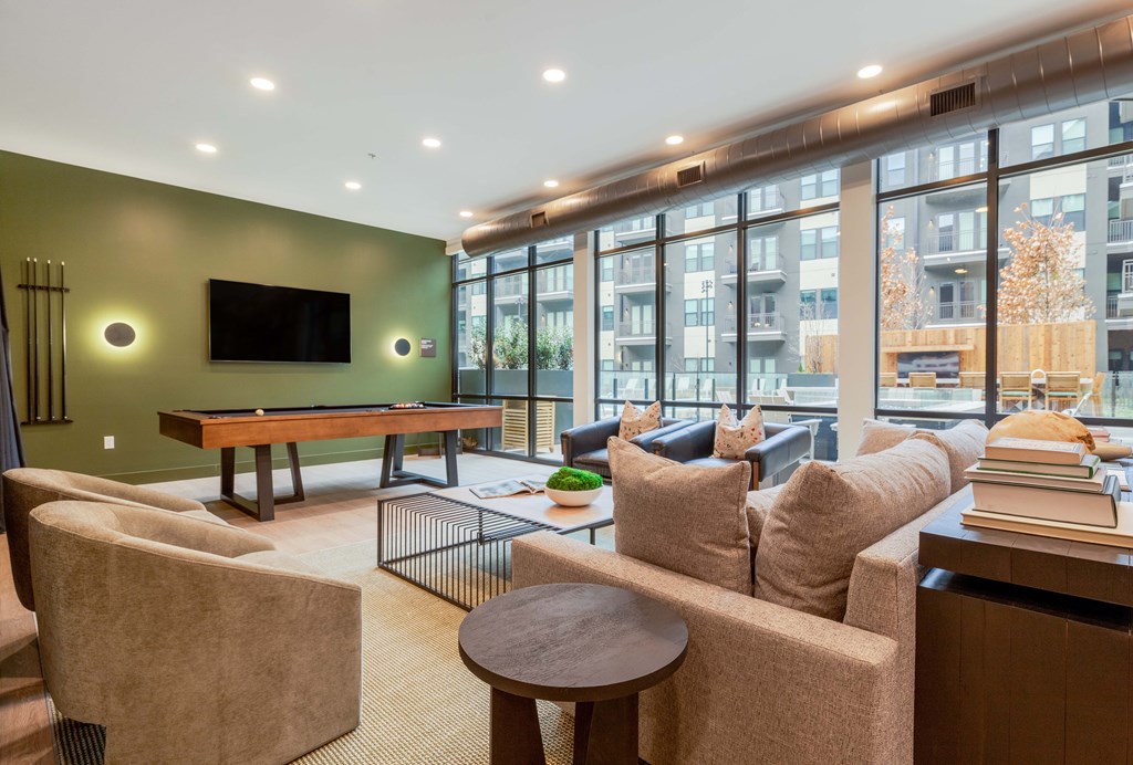 A living room with a flat screen TV mounted on the wall.