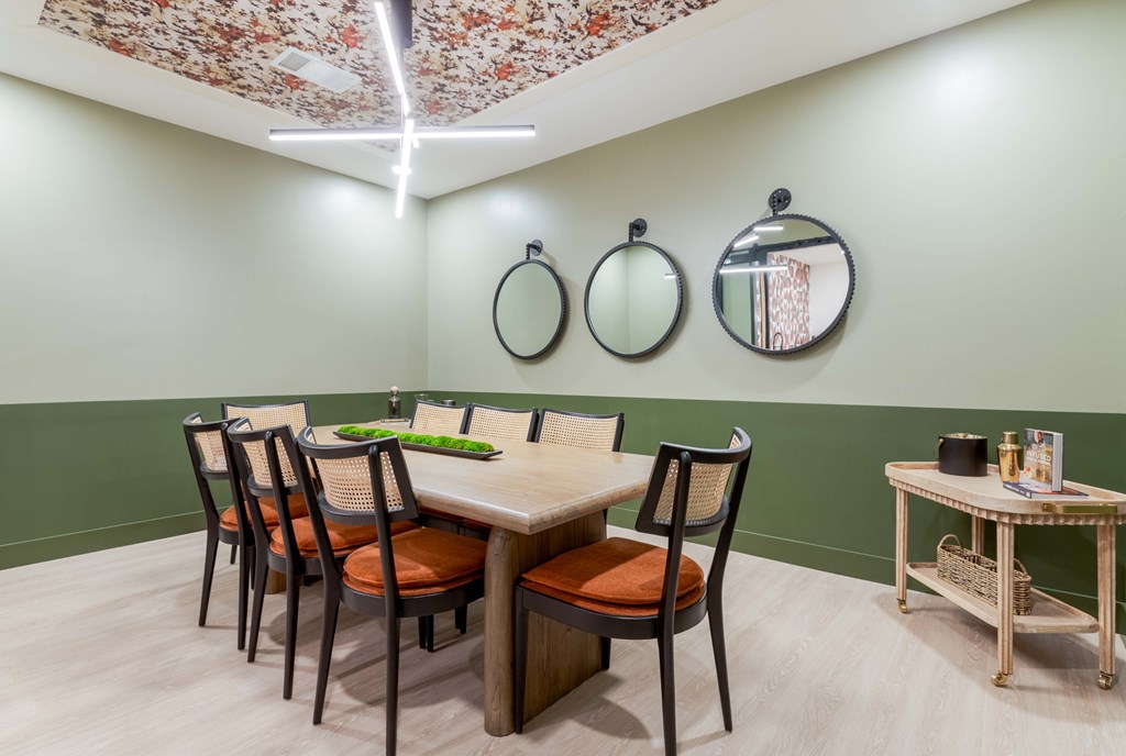 A dining room with a table set for four.