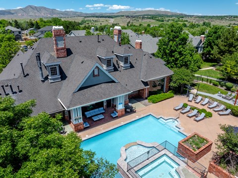 A large house with a pool and a mountain in the background.